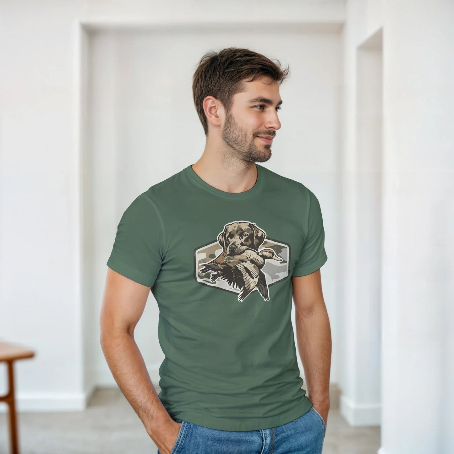 Man wearing olive green Duck Hunter's T-Shirt with graphic of hunting dog holding a duck.