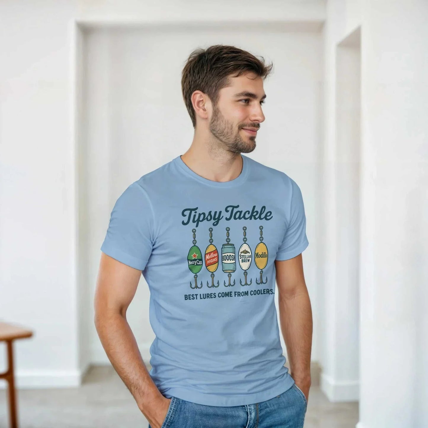 Man wearing light blue Tipsy Tackle T-Shirt with fishing lure graphic and "Best lures come from coolers" slogan