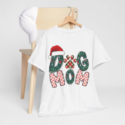 White Christmas Dog Mom tee with festive patterned lettering and Santa hat design on wooden hanger.