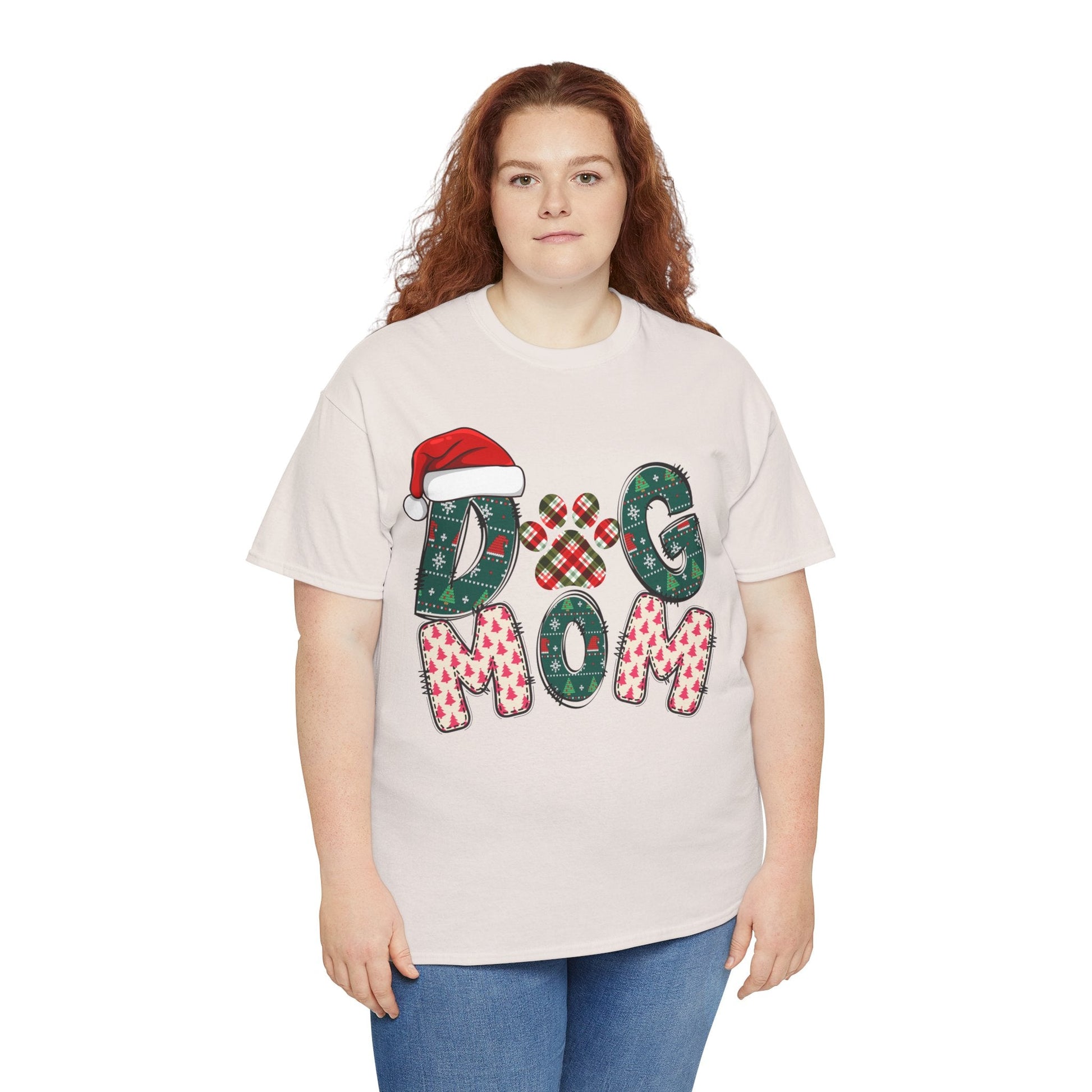 Plus size woman wearing a white Christmas Dog Mom Tee with festive holiday letters and Santa hat design