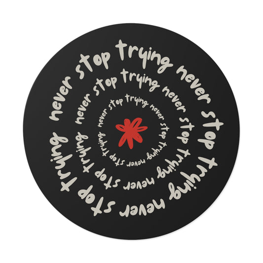 Don't Stop Trying round vinyl sticker with motivational spiral text and red star design on black background