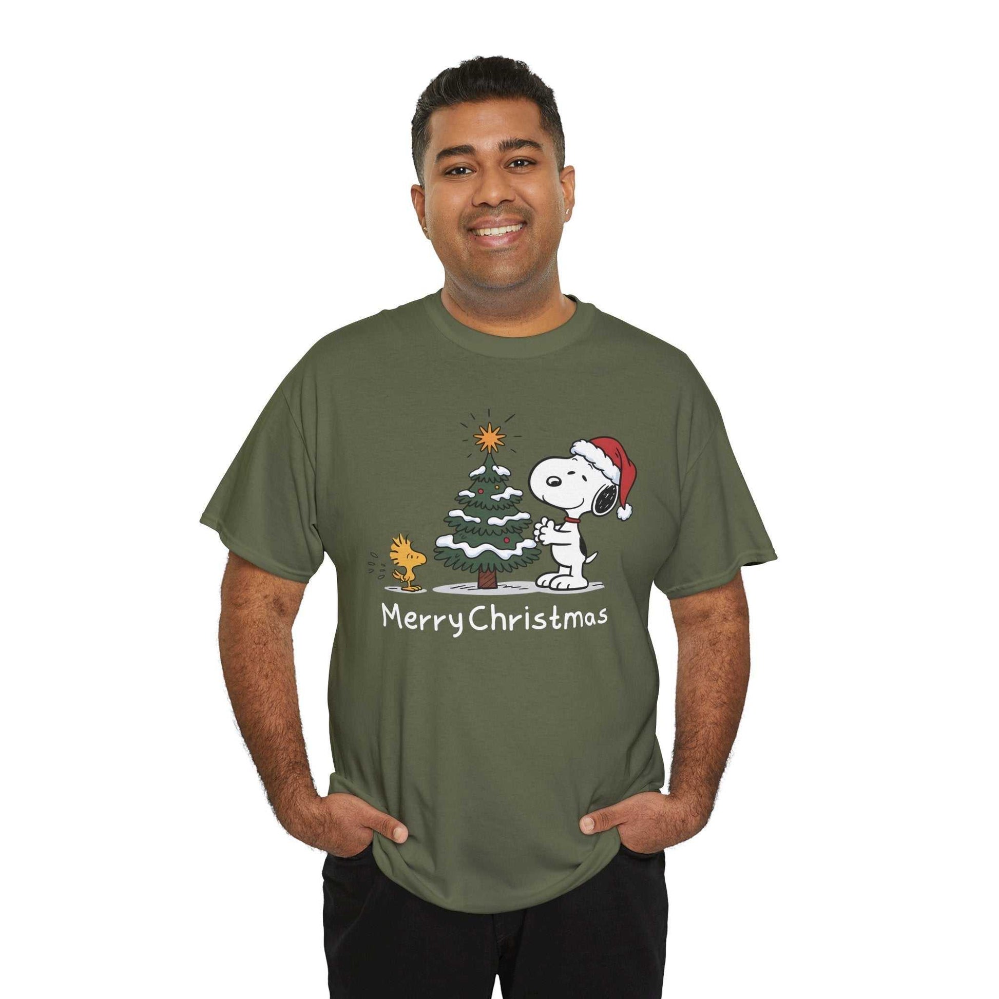 Man wearing olive green Snoopy & Woodstock Merry Christmas holiday T-shirt with Snoopy in Santa hat and Christmas tree graphic