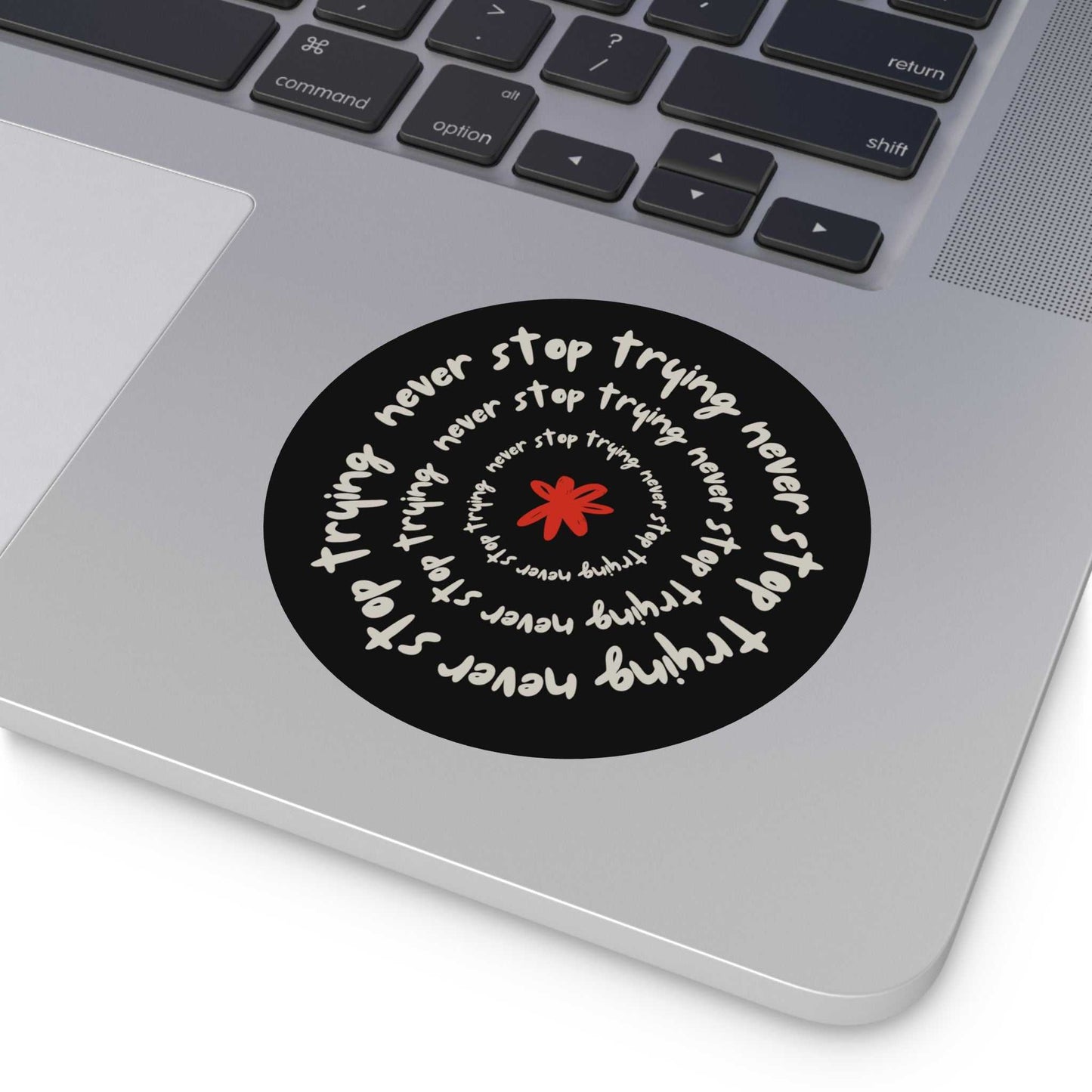 Don't Stop Trying round vinyl sticker with motivational text spiral design on laptop