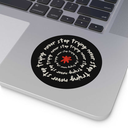 Don't Stop Trying round vinyl sticker with motivational text spiral design on laptop