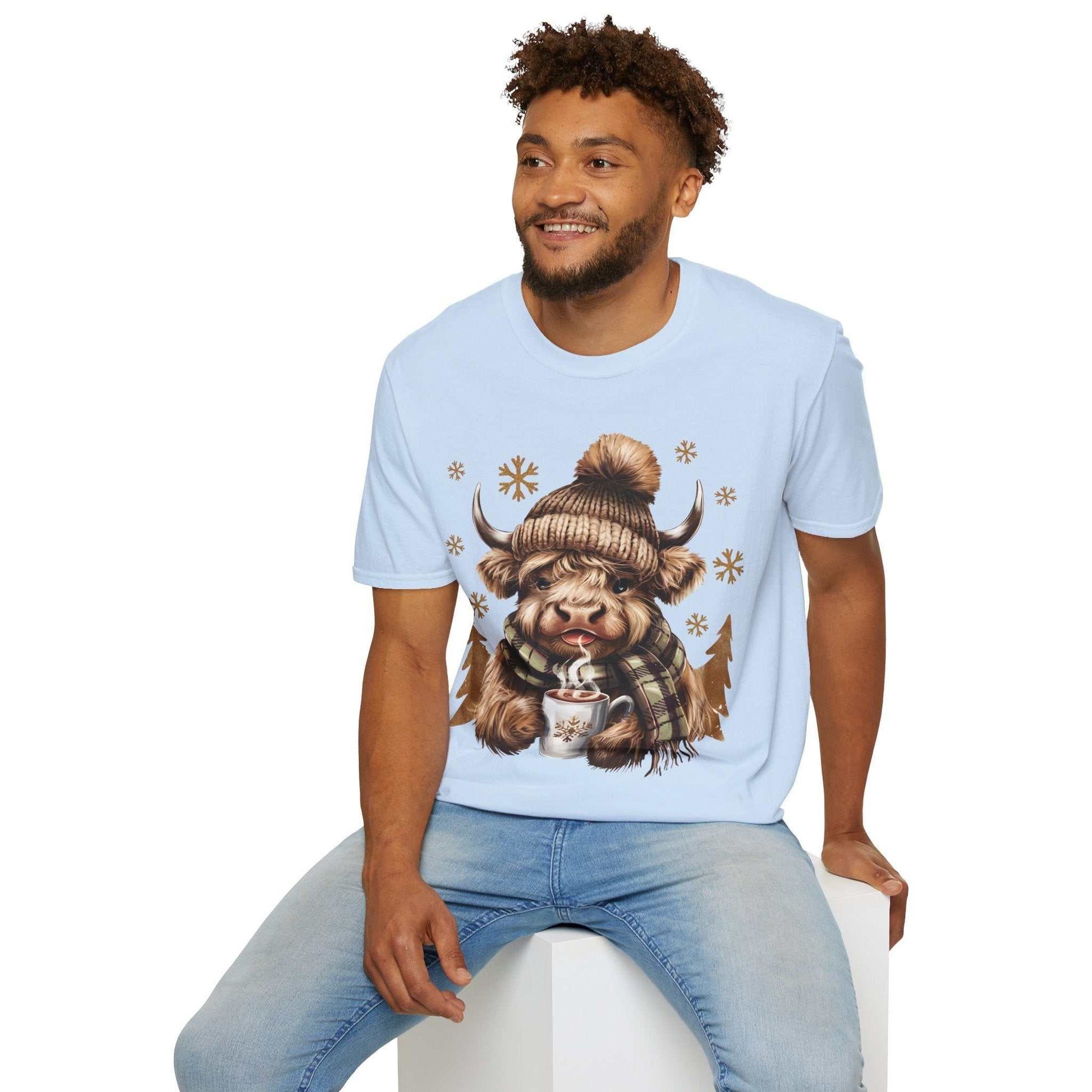 Man wearing light blue Highland Cow and Hot Chocolate T-Shirt with cozy winter design