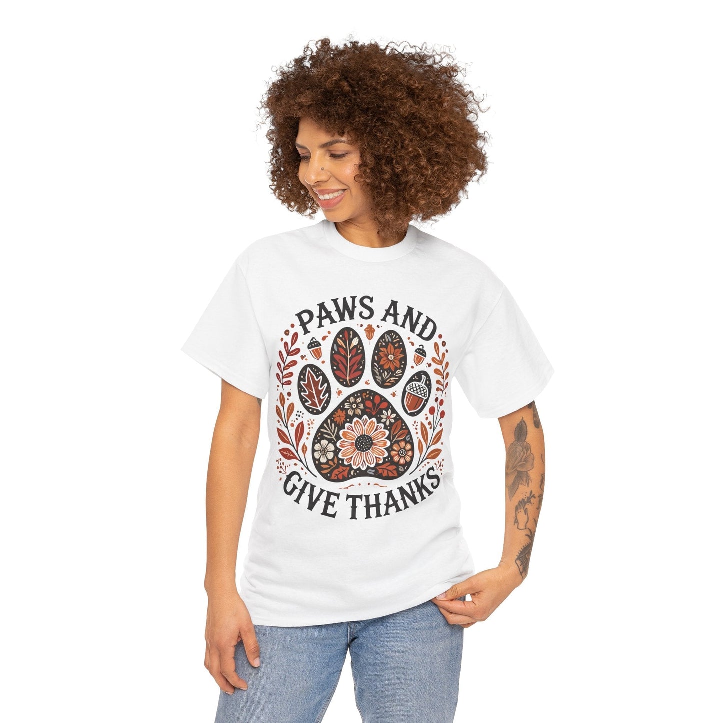 Woman wearing white Paws and Give Thanks t-shirt with autumn-themed paw print design