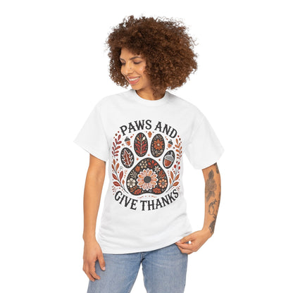 Woman wearing white Paws and Give Thanks t-shirt with autumn-themed paw print design
