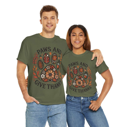 Couple wearing olive green "Paws and Give Thanks" t-shirts with autumn-themed paw print design