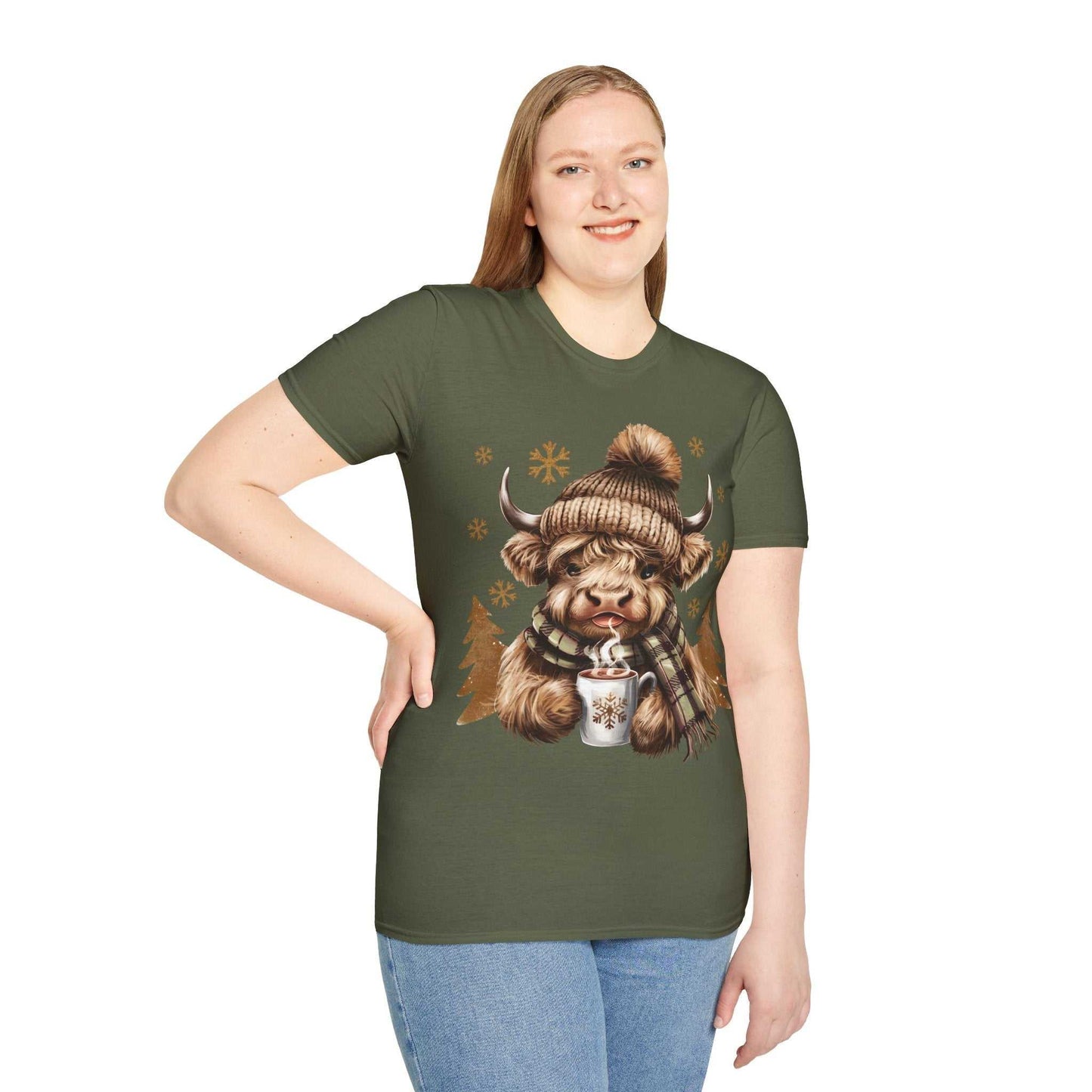 Woman wearing green Highland Cow t-shirt with cozy winter cow, hat, scarf, and hot chocolate design