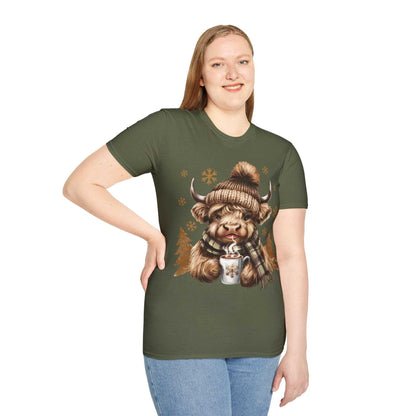 Woman wearing green Highland Cow t-shirt with cozy winter cow, hat, scarf, and hot chocolate design