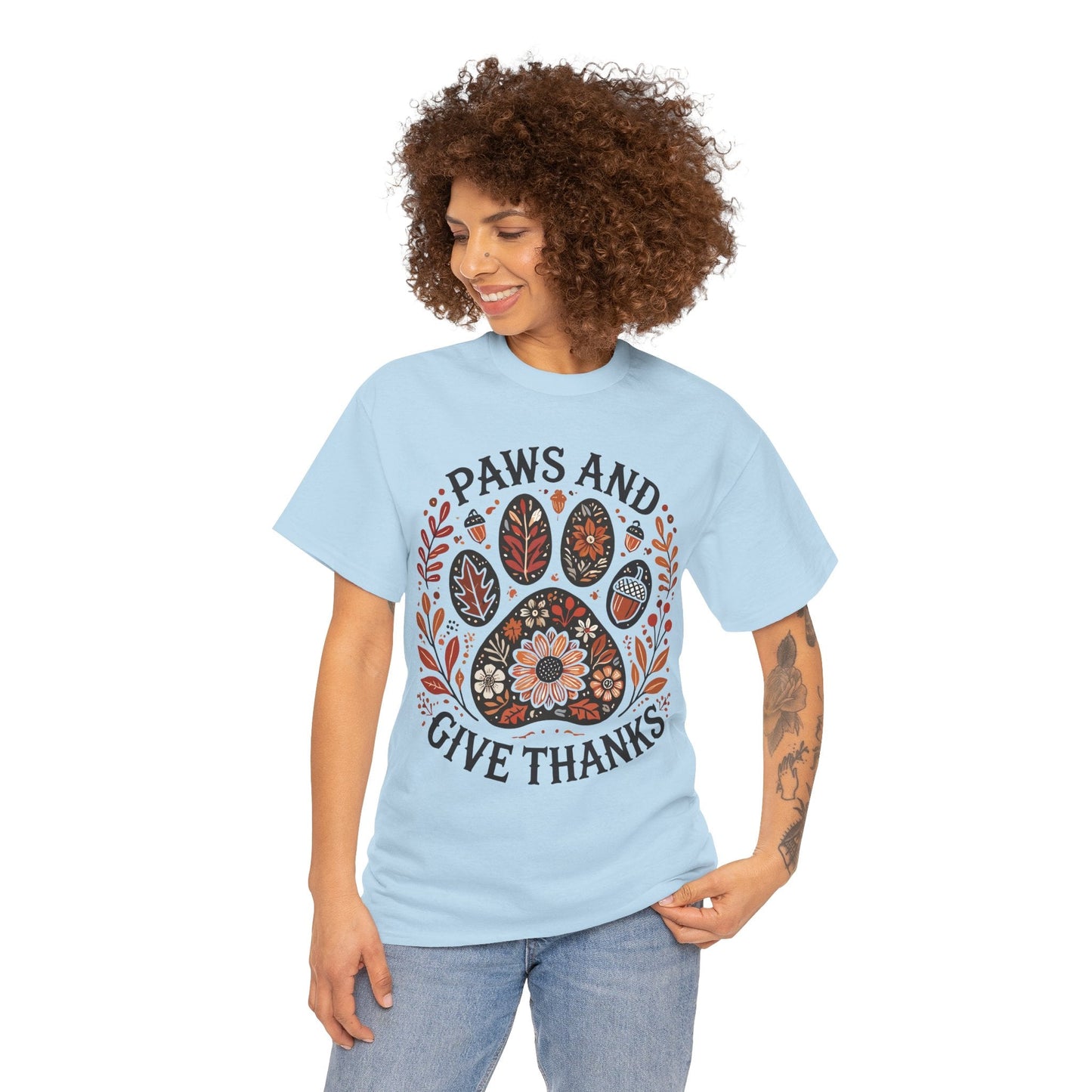 Woman wearing light blue Paws and Give Thanks t-shirt with autumn paw print design