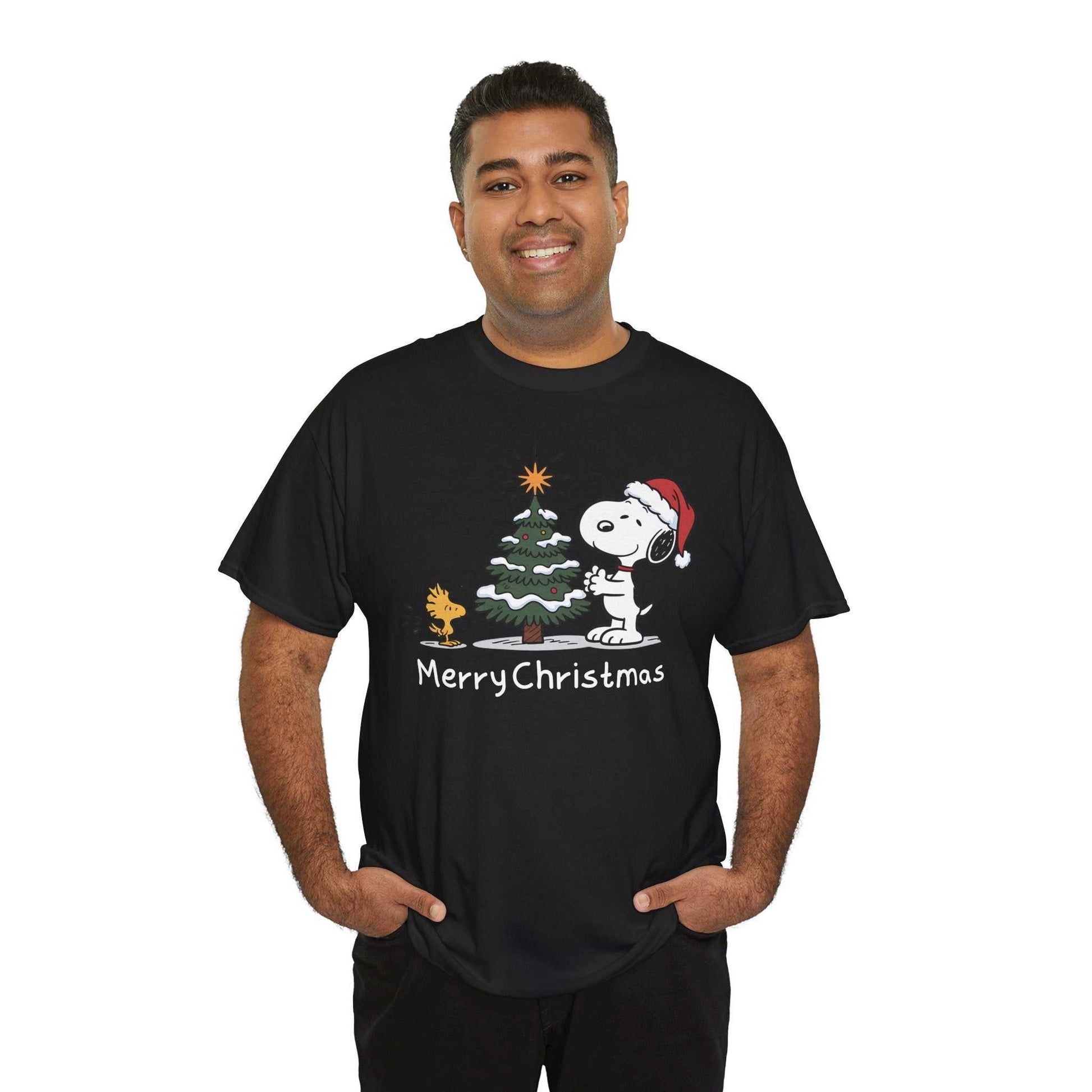 Man wearing black Snoopy & Woodstock Merry Christmas T-shirt with Snoopy in Santa hat and Christmas tree design