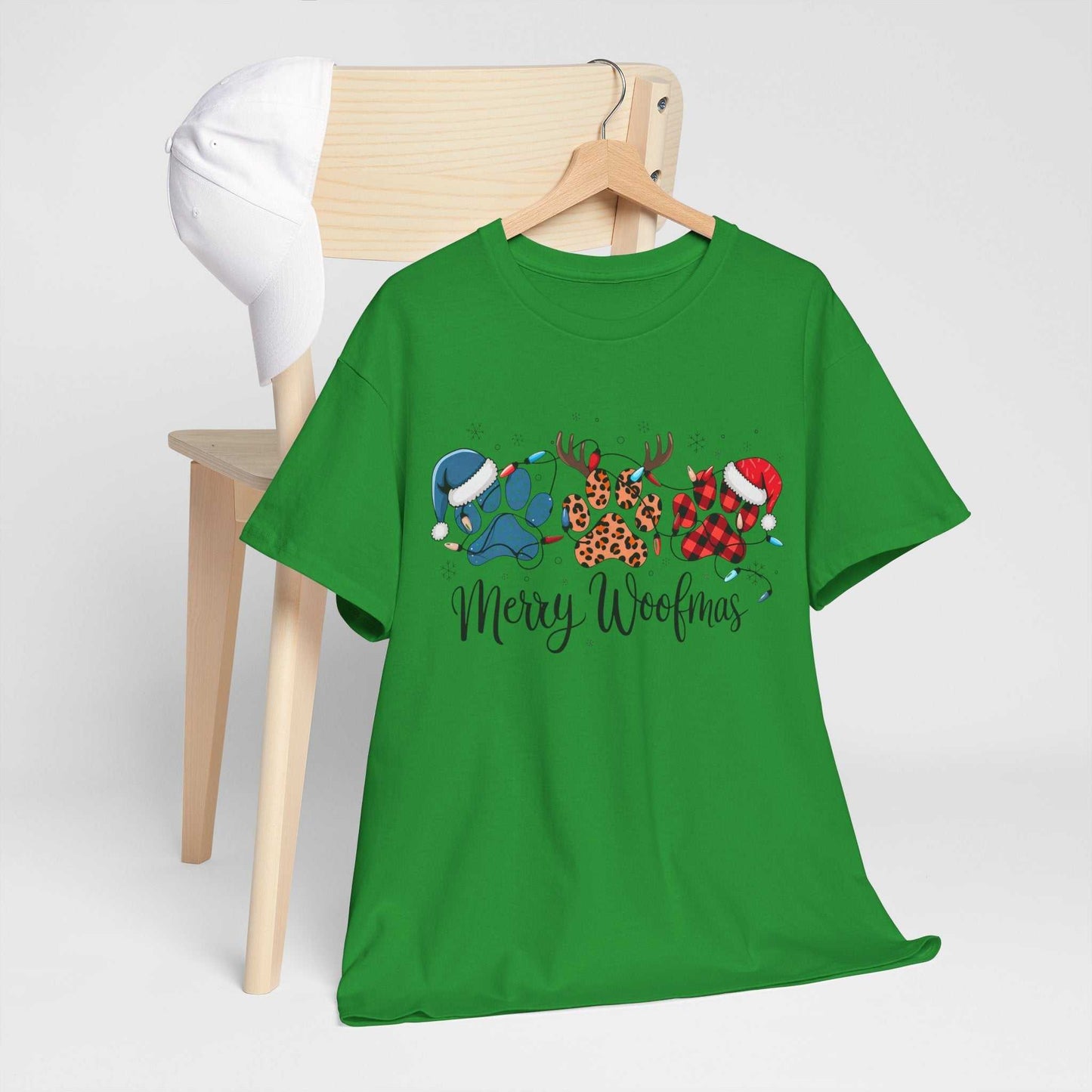 Green "Merry Woofmas" Christmas tee with festive paw prints in buffalo plaid, leopard spots, and holiday lights designs.