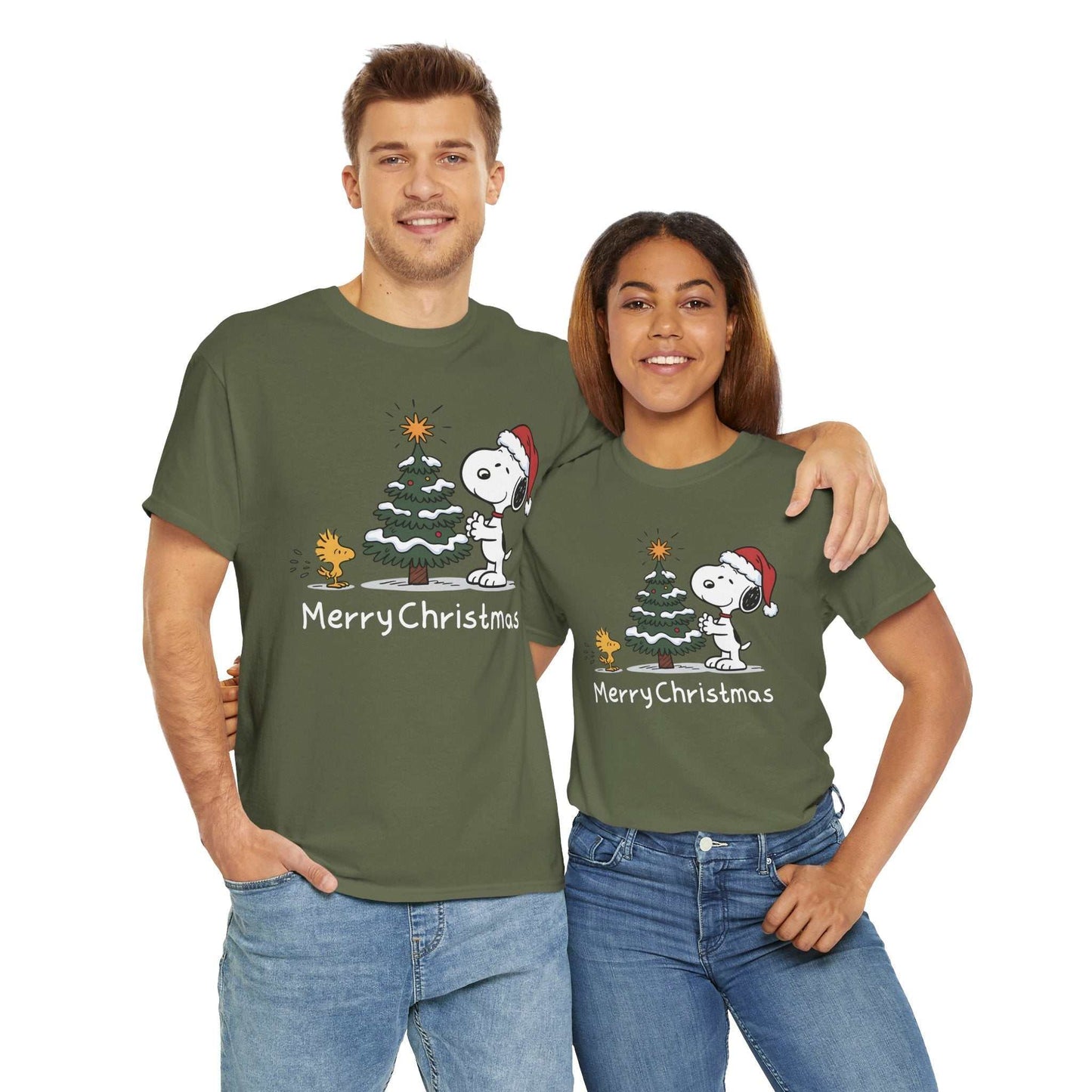 Couple wearing green Snoopy & Woodstock Merry Christmas T-shirts with festive tree graphic