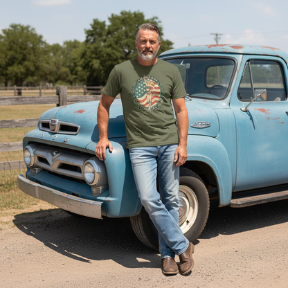 Man wearing Vintage Americana Cowgirl Emblem T-Shirt standing by a blue vintage truck outdoors