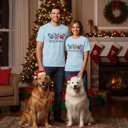 Couple wearing light blue Merry Woofmas paw print Christmas tees with holiday decorated dogs in cozy living room