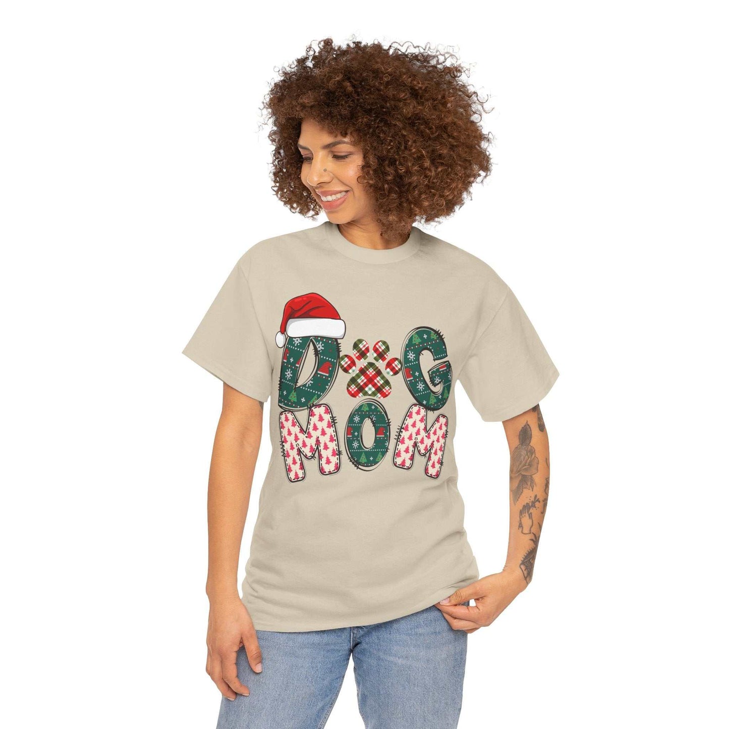Woman wearing beige Christmas Dog Mom Tee with festive holiday-themed lettering and Santa hat design