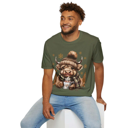 Man wearing Highland Cow t-shirt with winter hat, scarf, and hot chocolate design on green cotton tee