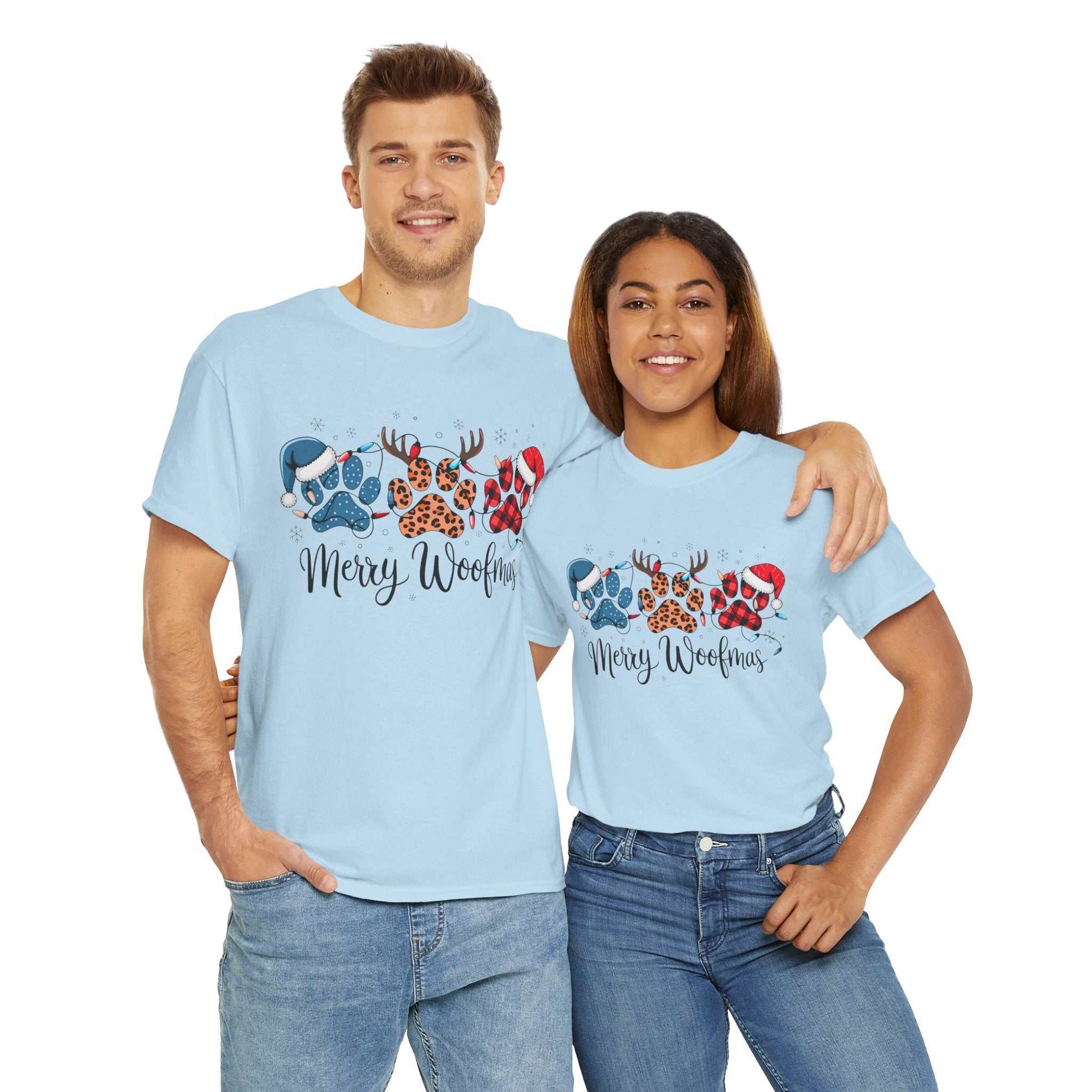 Couple wearing light blue Merry Woofmas Christmas tees with festive paw print designs including plaid, leopard spots, and holiday elements
