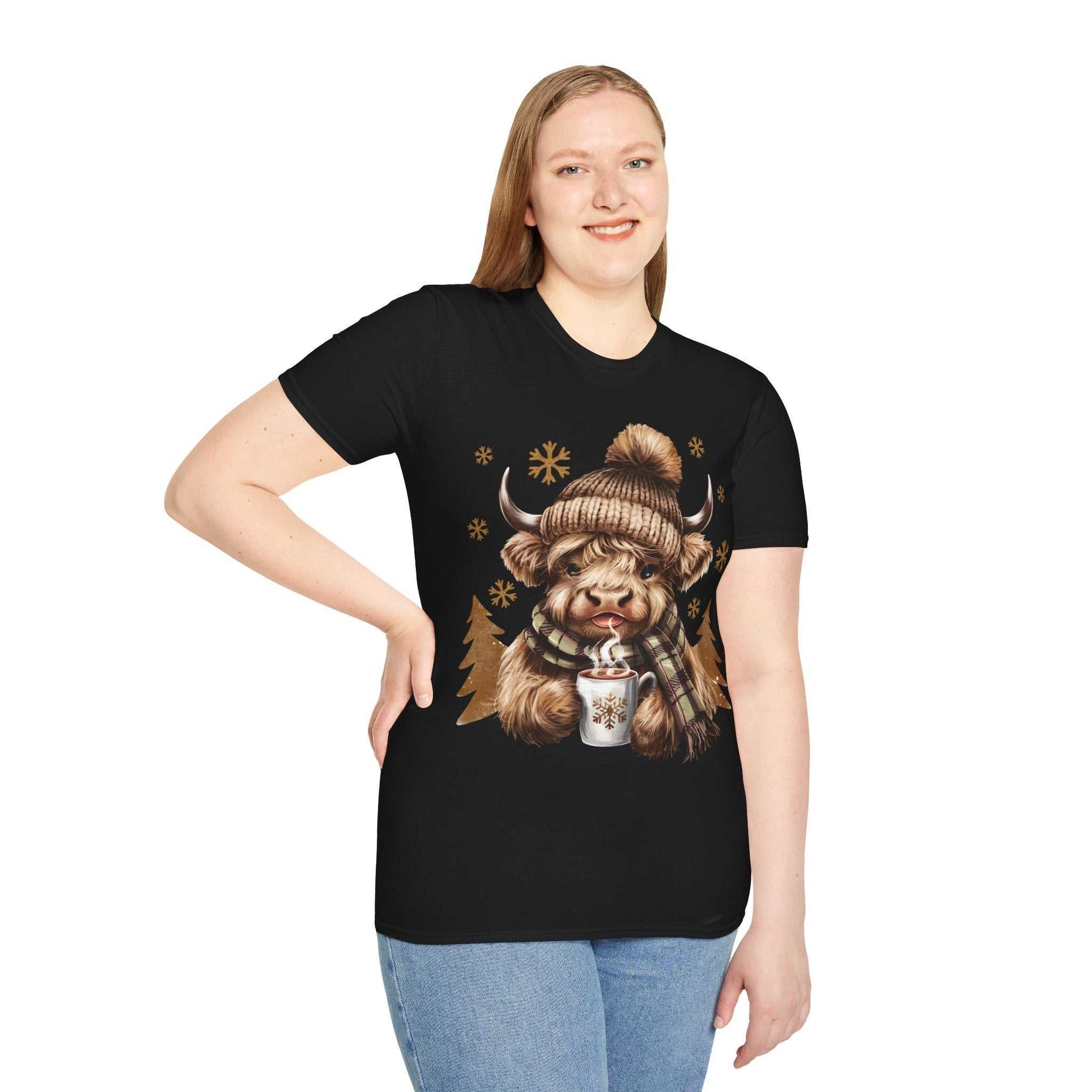 Woman wearing black t-shirt with Highland Cow in winter hat holding hot chocolate design
