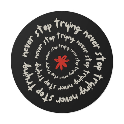 Don't Stop Trying round vinyl sticker with motivational text spiral design and red star center on black background