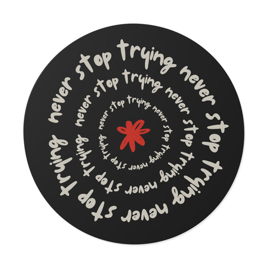 Don't Stop Trying round vinyl sticker with motivational text spiral design and red star center on black background
