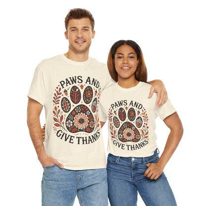 Couple wearing "Paws and Give Thanks" t-shirts with autumn paw print design and fall foliage accents