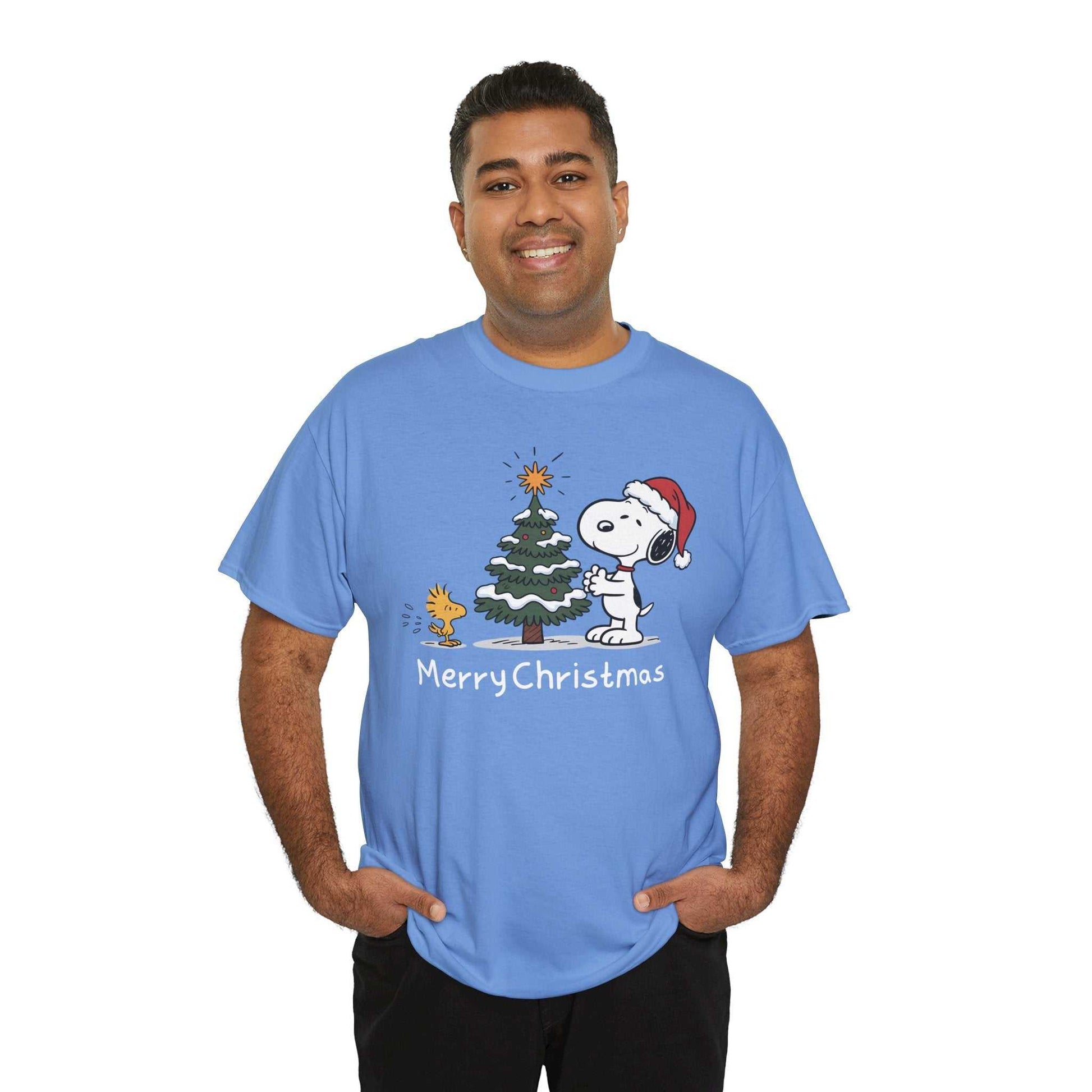 Man wearing blue Snoopy & Woodstock Merry Christmas holiday t-shirt with Santa hat and Christmas tree design