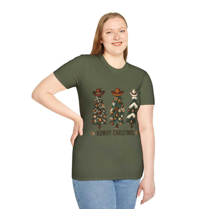 Woman wearing military green Howdy Christmas Cowboy Tree T-shirt with three decorated Christmas trees topped with cowboy hats.