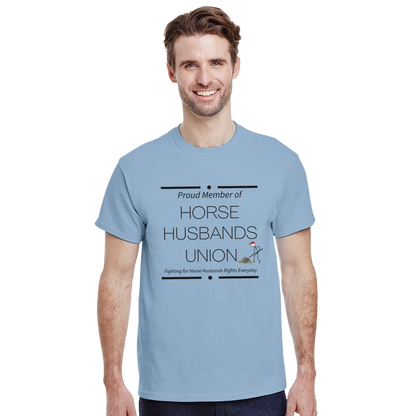 Man wearing light blue Horse Husbands Union t-shirt with humorous text and graphic of man shoveling money
