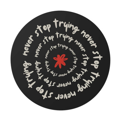 Don't Stop Trying motivational round vinyl sticker with spiral text and red star on black background