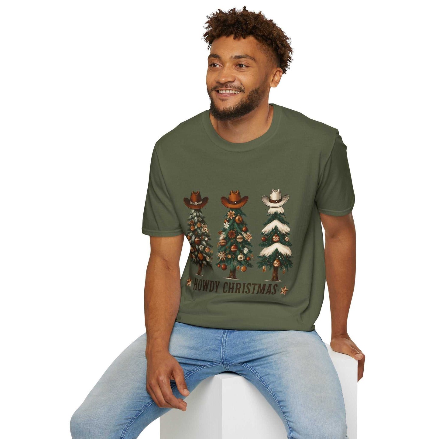 Man wearing a military green Howdy Christmas Cowboy Tree T-Shirt with three decorated Christmas trees topped with cowboy hats design