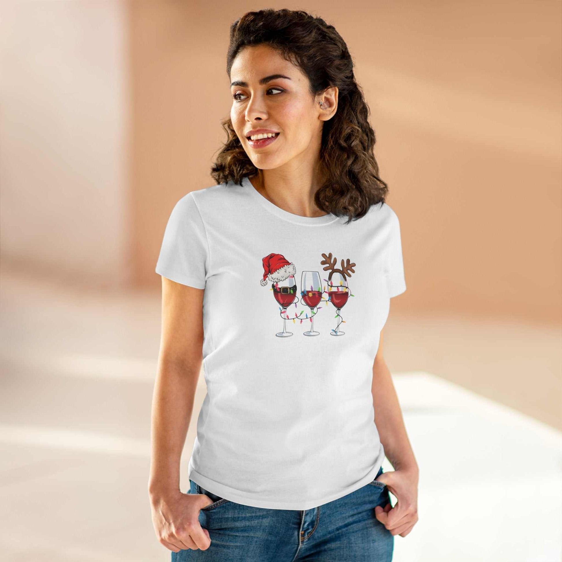 Woman wearing white Wine Glasses Christmas T-Shirt with festive wine glass designs featuring Santa hat and reindeer antlers