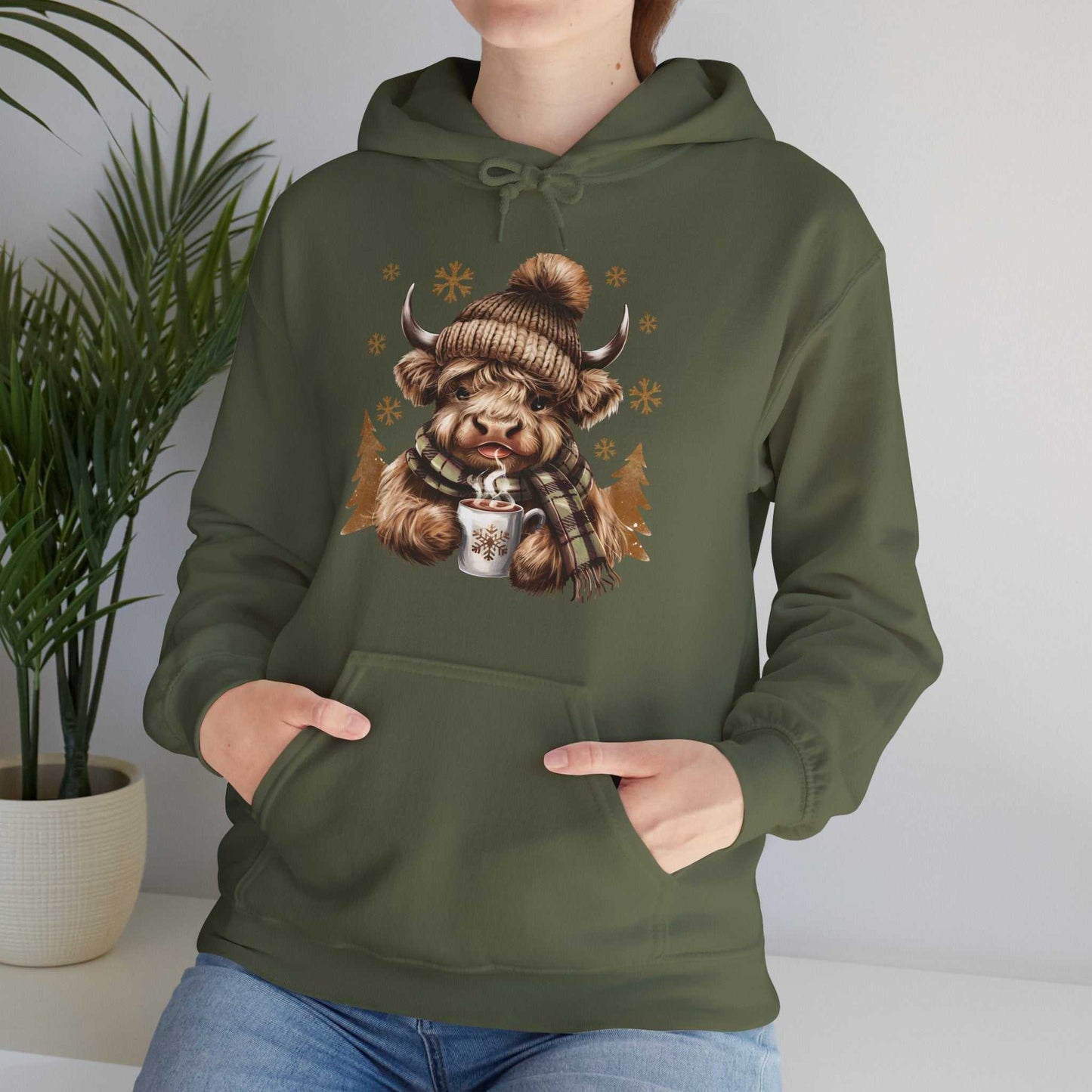 Olive green Highland Cow Hoodie with winter hat, plaid scarf, and hot chocolate design, cozy unisex fit.