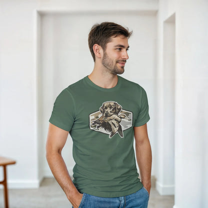Man wearing olive green Duck Hunter's T-Shirt with graphic of hunting dog holding a duck.