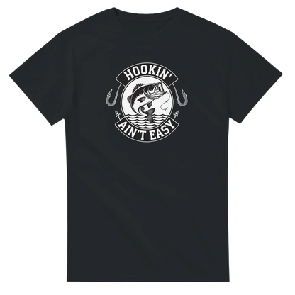 Hookin' Ain't Easy T-Shirt in black with fishing graphic and humorous text for fishing enthusiasts
