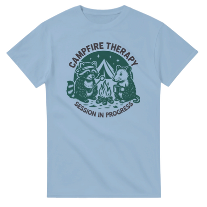 Light blue Cute Campfire Therapy T-shirt with raccoon and bear campfire design and "Session in Progress" text