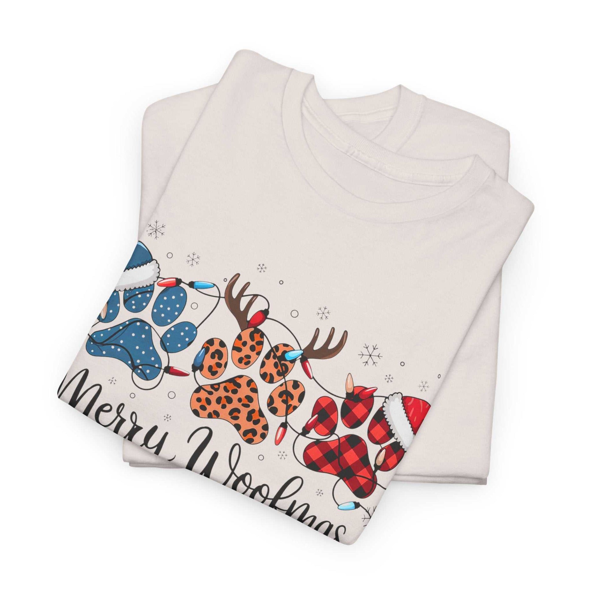 Folded white t-shirt with Merry Woofmas paw print design in plaid, leopard, and Christmas themes