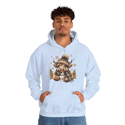 Light blue Highland Cow Hoodie with cozy winter cow design and hot chocolate mug