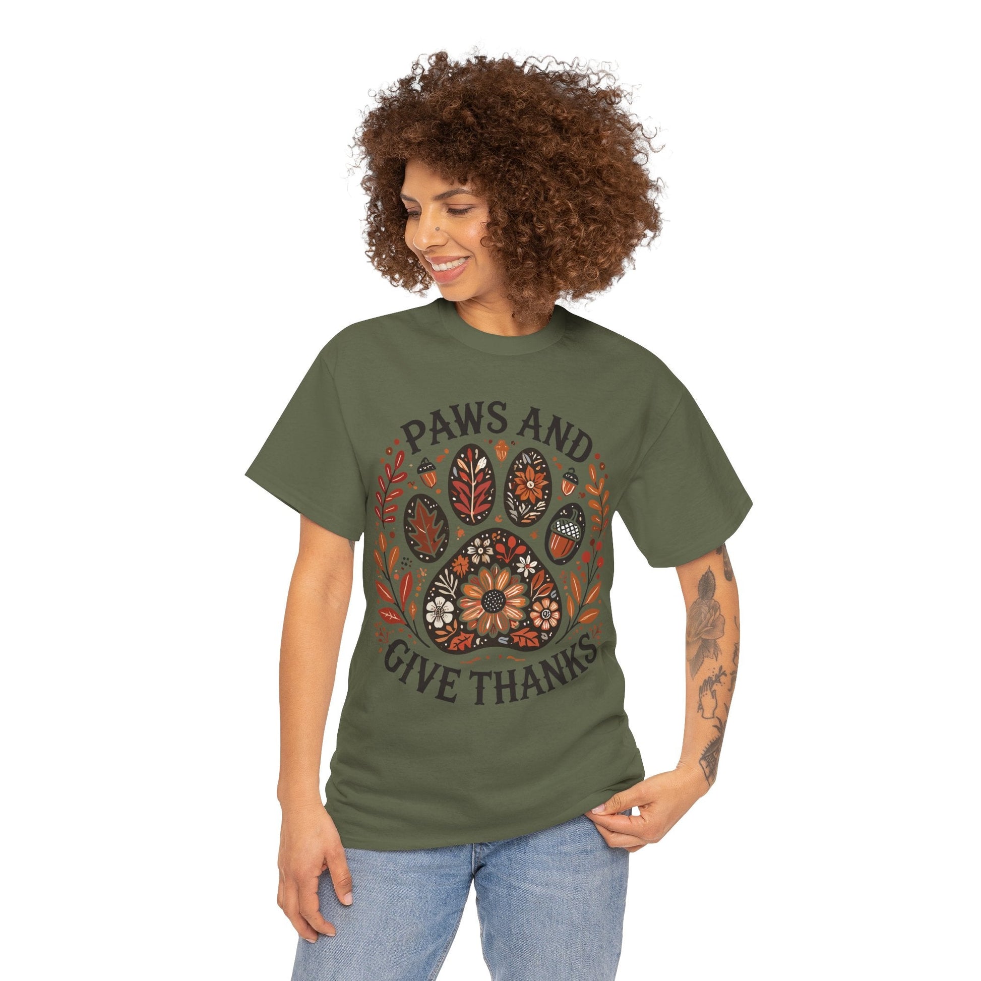 Woman wearing olive green Paws and Give Thanks t-shirt with autumn paw print design and floral accents