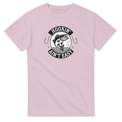 Hookin' Ain't Easy T-Shirt with fishing graphic in pink heavyweight cotton