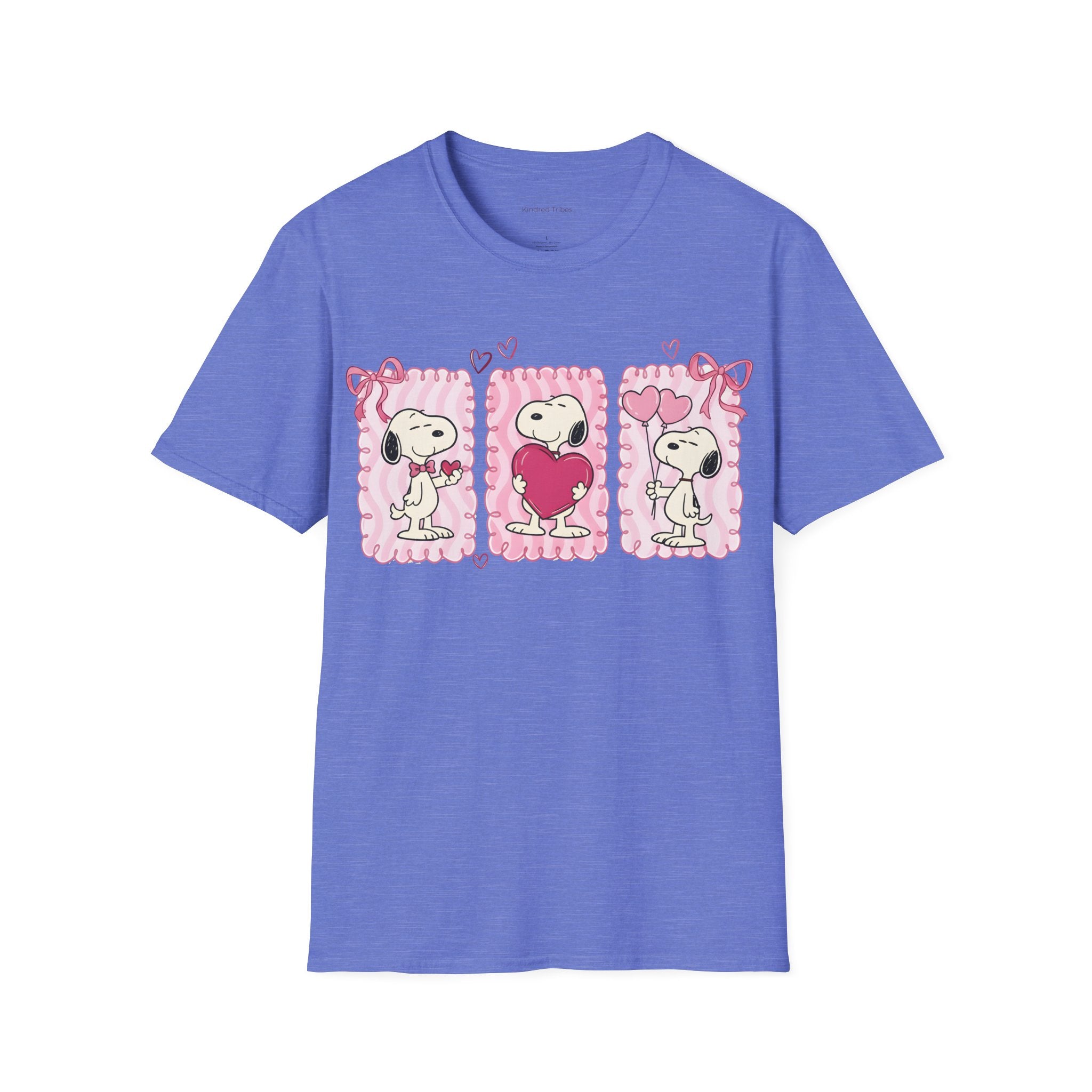 Heather Royal Blue T-shirt with three distinct panels of Snoopy—sharing a small heart, hugging a giant one, and holding heart-shaped balloons—this tee is a playful celebration of friendship, affection, and the "Puppy Love" spirit.