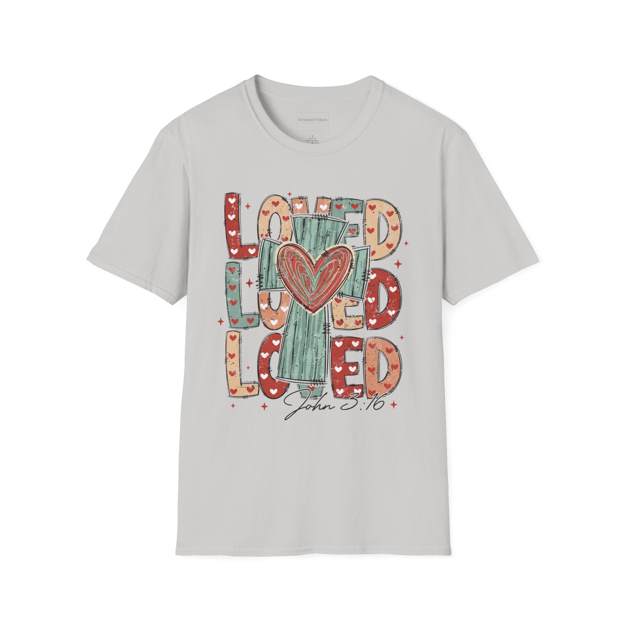 Light Grey Loved Cross Heart T-Shirt featuring a large, colorful graphic on the front. The design consists of the word "LOVED" repeated three times in a stacked, chunky block font. The letters are filled with various patterns, including solid colors, stripes, and small hearts in shades of red, sage green, and tan. In the center of the text is a distressed, teal-colored cross with a large, hand-drawn red heart layered over the middle. Below the main graphic, the scripture reference "John 3:16" is written.