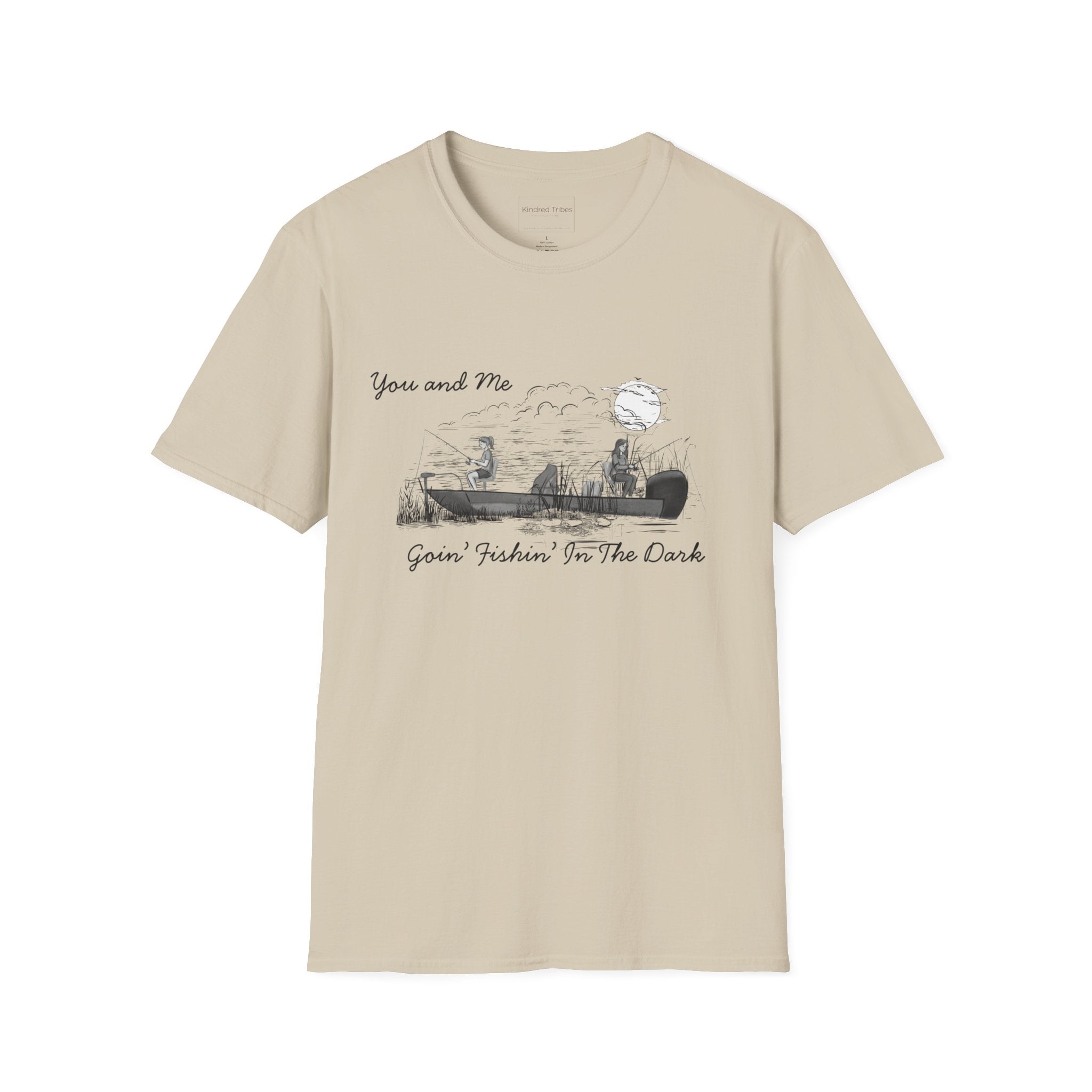 The Best Friends Fishin' In The Dark T-Shirt shows two women in a fishing boat fishing with the moon shining down in a black and white hand sketched print design on a beige cotton tee.
