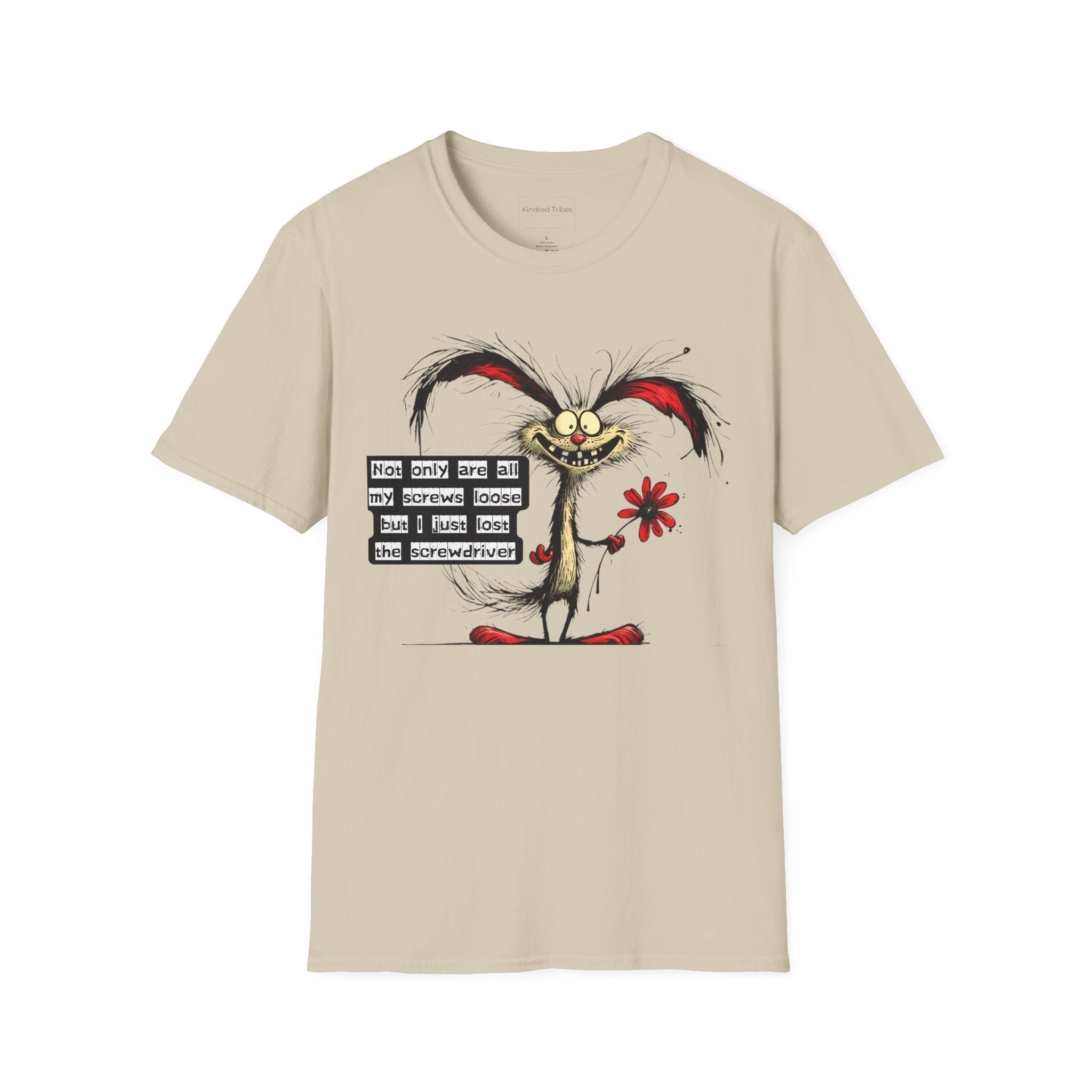 A beige unisex Loose Screws t-shirt featuring a whimsical, chaotic cartoon character with frayed black hair, red-tipped ears, and a wide, toothy grin. The character has large, wide eyes and is holding a single red flower in one hand. To the left of the character, a black text box with white, typewriter-style lettering reads: "Not only are all my screws loose but I just lost the screwdriver." The shirt is shown flat against a white background.