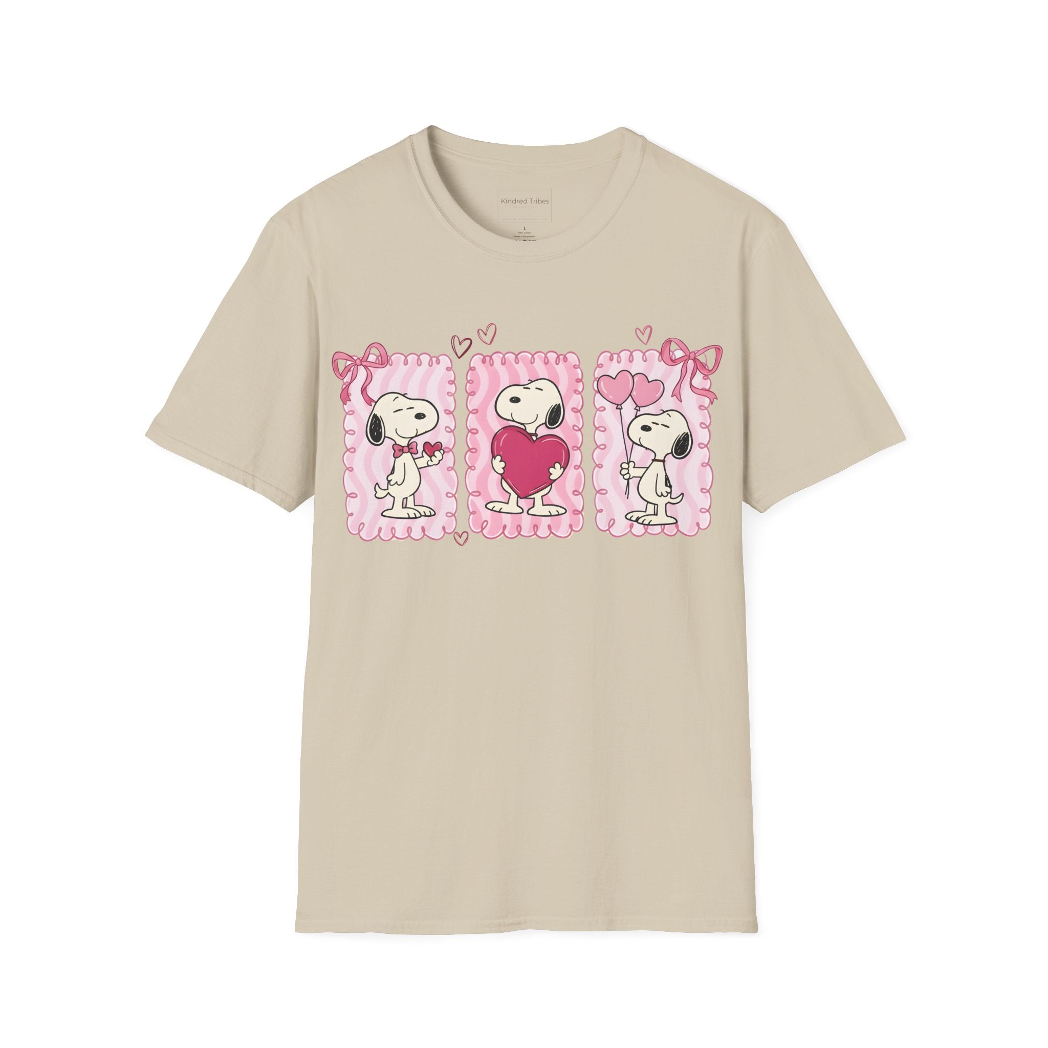 Beige T-shirt with three distinct panels of Snoopy—sharing a small heart, hugging a giant one, and holding heart-shaped balloons—this tee is a playful celebration of friendship, affection, and the "Puppy Love" spirit.