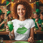 Woman at a St Patrick's Day party holding a green drink and wearing a white Identify As Irish T-Shirt featuring the text 'I IDENTIFY AS IRISH' in bold green celtic letters at the top. Below the text is a large pair of lips filled with a sparkling, vibrant green sequin-effect pattern. At the bottom, the phrase 'KISS ME ALREADY' is printed in a matching green font. 