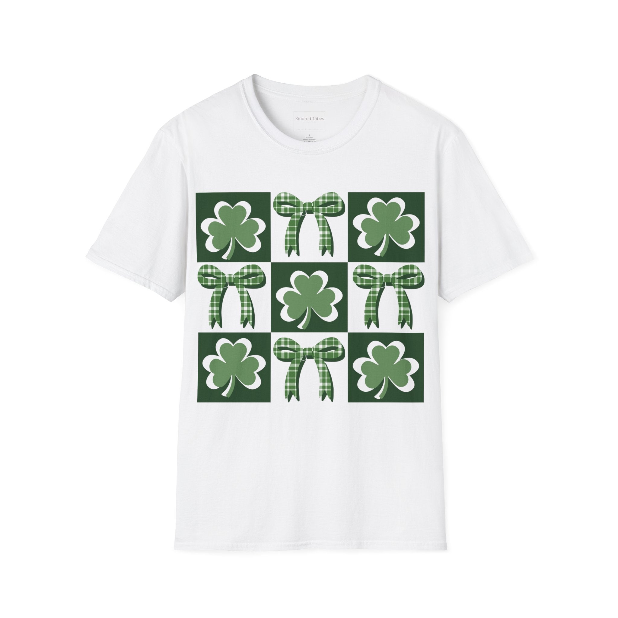 A white Lucky Coquette t-shirt featuring a 3x3 square grid graphic. The grid alternates between squares with a solid dark green background containing a white-outlined green shamrock and white squares containing a green-and-white checkered bow. The design is modern, symmetrical, and preppy in style
