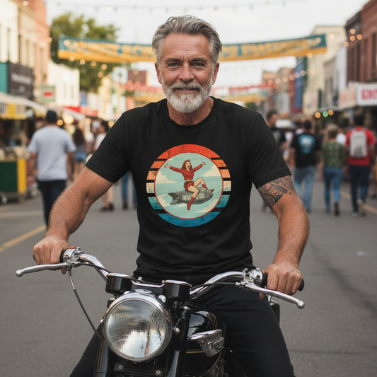 Man wearing black Devastator T-Shirt with vintage WWII bomber nose art pin-up girl design on motorcycle in street setting